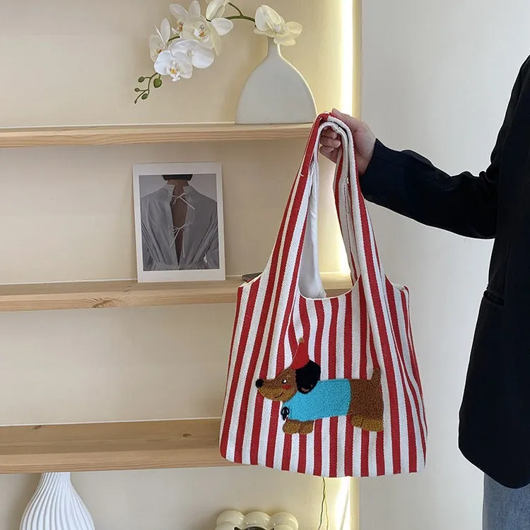 Soft canvas shoulder bag with red stripes and cartoon embroidery of a puppy wearing a red hat, square vertical shape, double shoulder straps