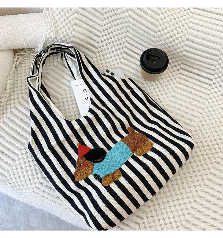 Soft canvas shoulder bag with red stripes and cartoon embroidery of a puppy wearing a red hat, square vertical shape, double shoulder straps