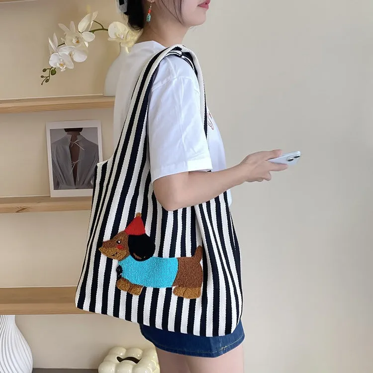 Soft canvas shoulder bag with red stripes and cartoon embroidery of a puppy wearing a red hat, square vertical shape, double shoulder straps