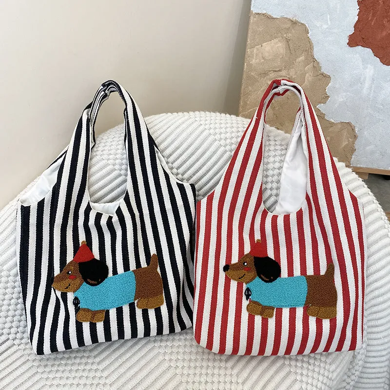 Soft canvas shoulder bag with red stripes and cartoon embroidery of a puppy wearing a red hat, square vertical shape, double shoulder straps