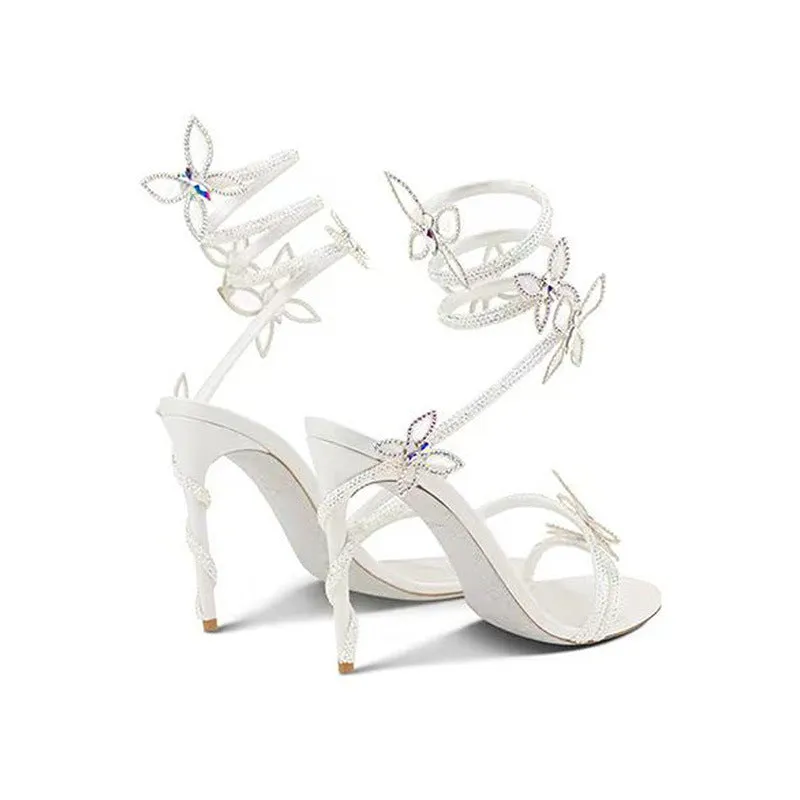 Snake butterfly rhinestone flower stiletto heel Roman sandals in gold with buckle closure and super high heel