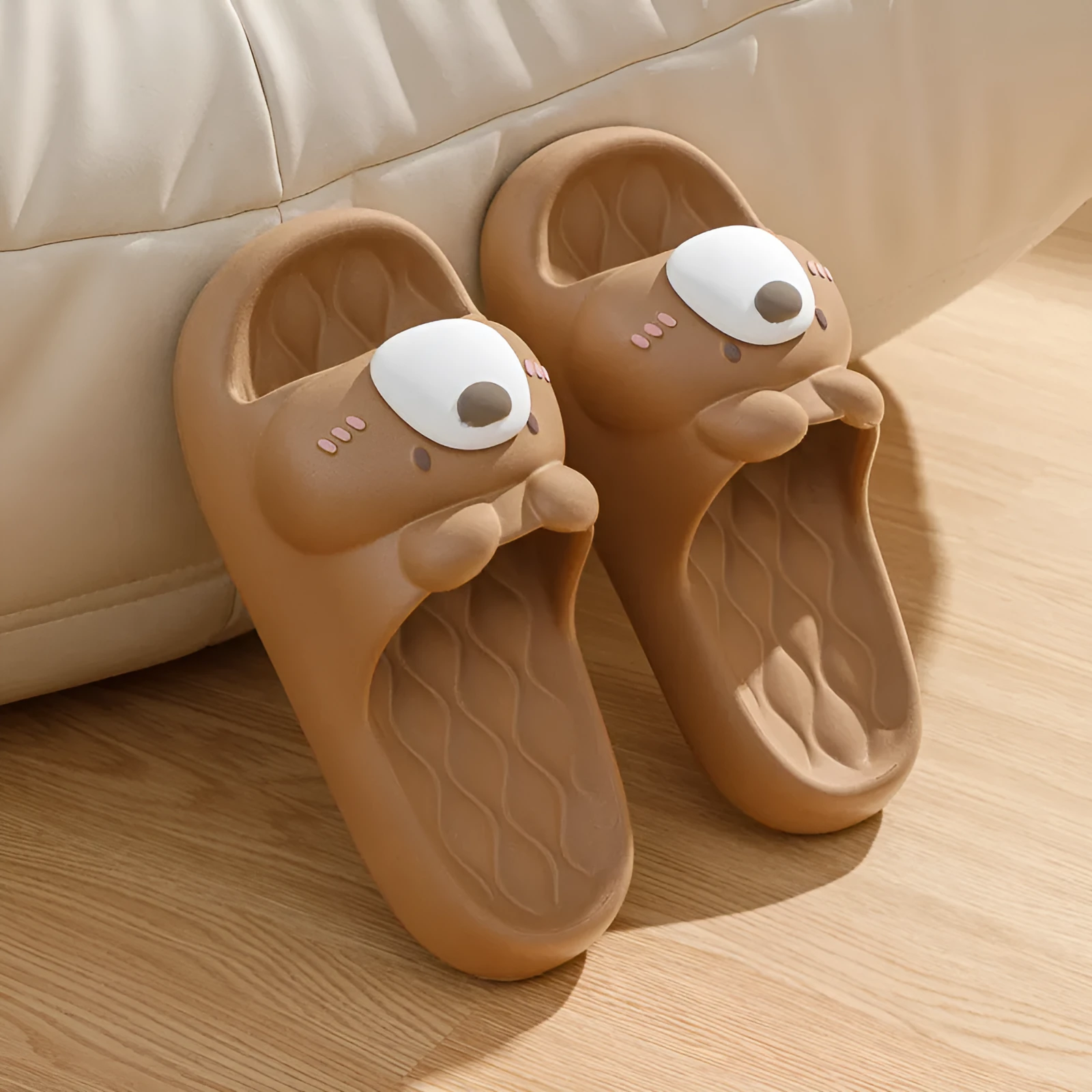 Pair of brown cartoon bear EVA flip flops for adults, toe baring sandal style