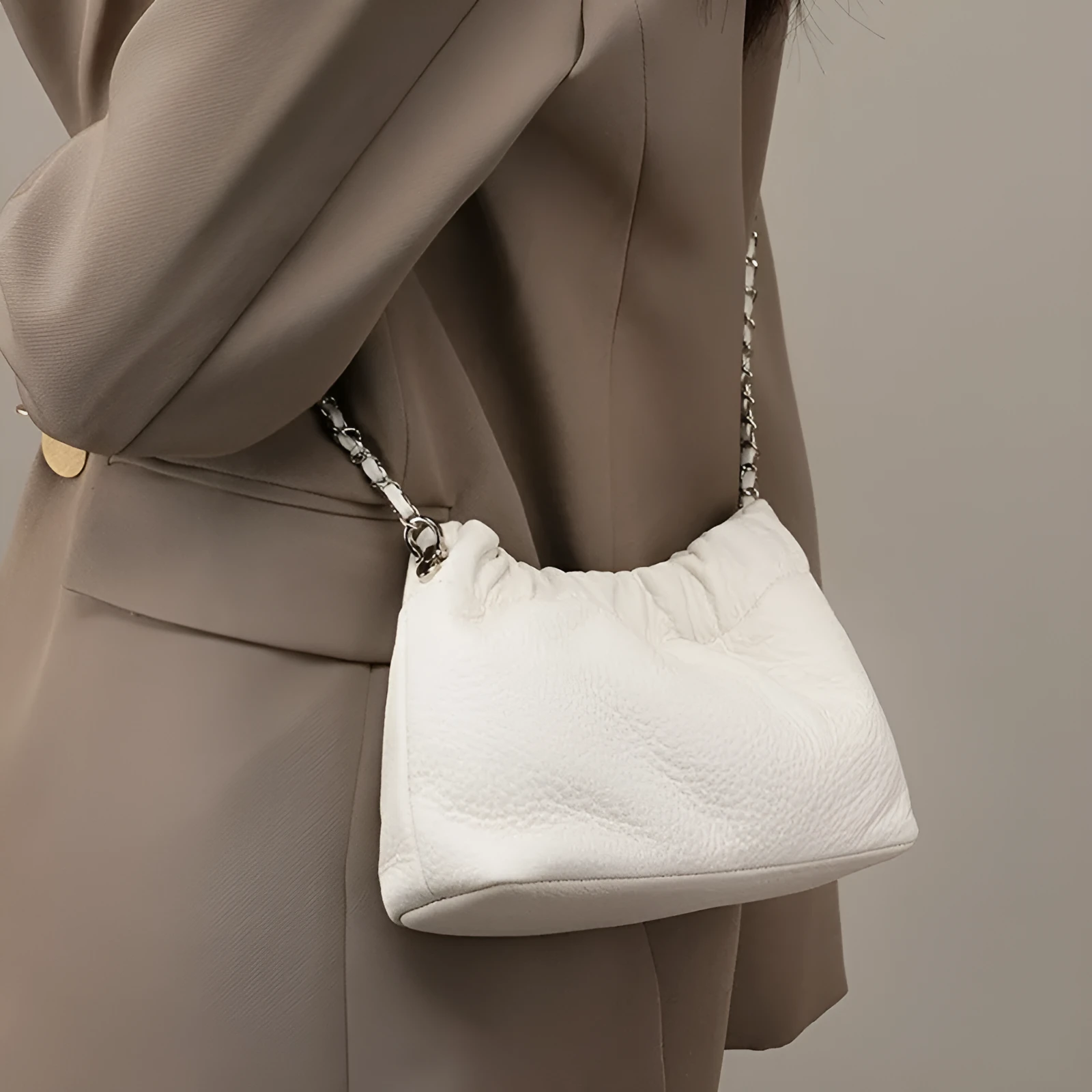 Women's soft genuine leather dumpling-shaped crossbody bag in grey with a chain shoulder strap.