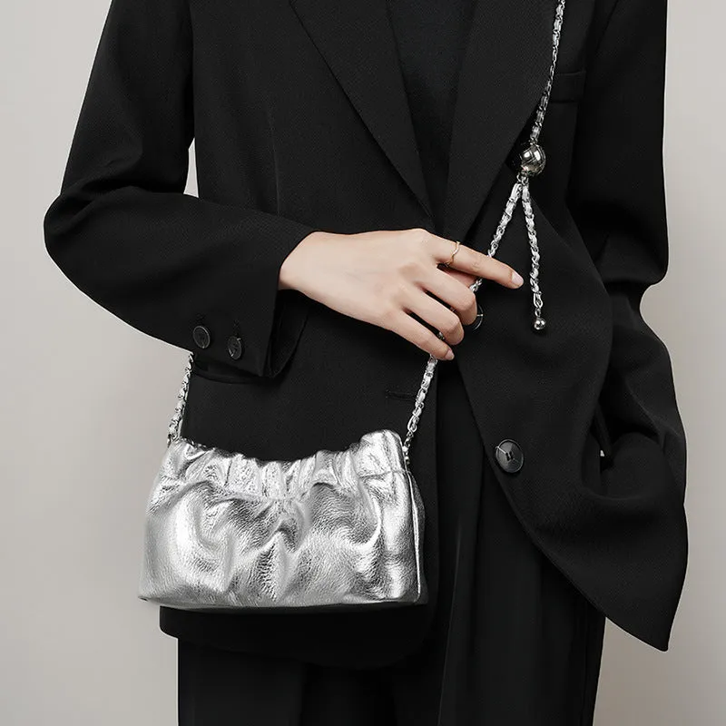 Women's soft genuine leather dumpling-shaped crossbody bag in grey with a chain shoulder strap.