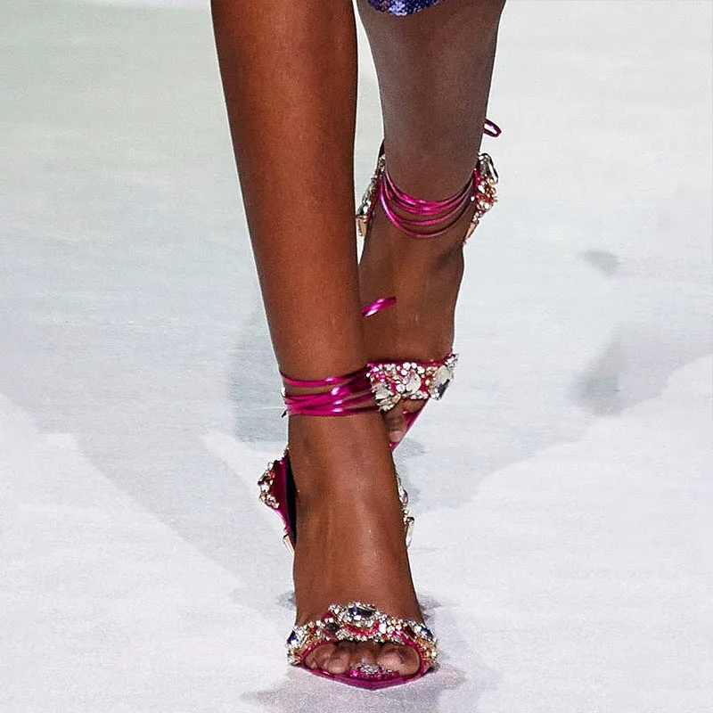 Super high heel pointed toe rhinestone slingback heels in gold on display