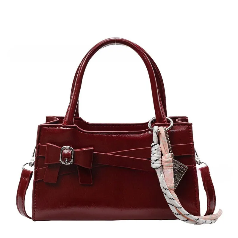 Soft nylon crossbody bag in urban simplicity, horizontal square shape, beige colour with flap pocket and stitching details.