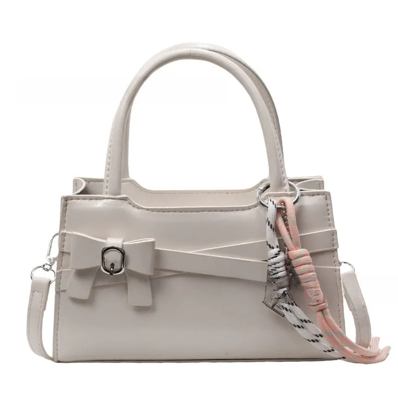 Soft nylon crossbody bag in urban simplicity, horizontal square shape, beige colour with flap pocket and stitching details.