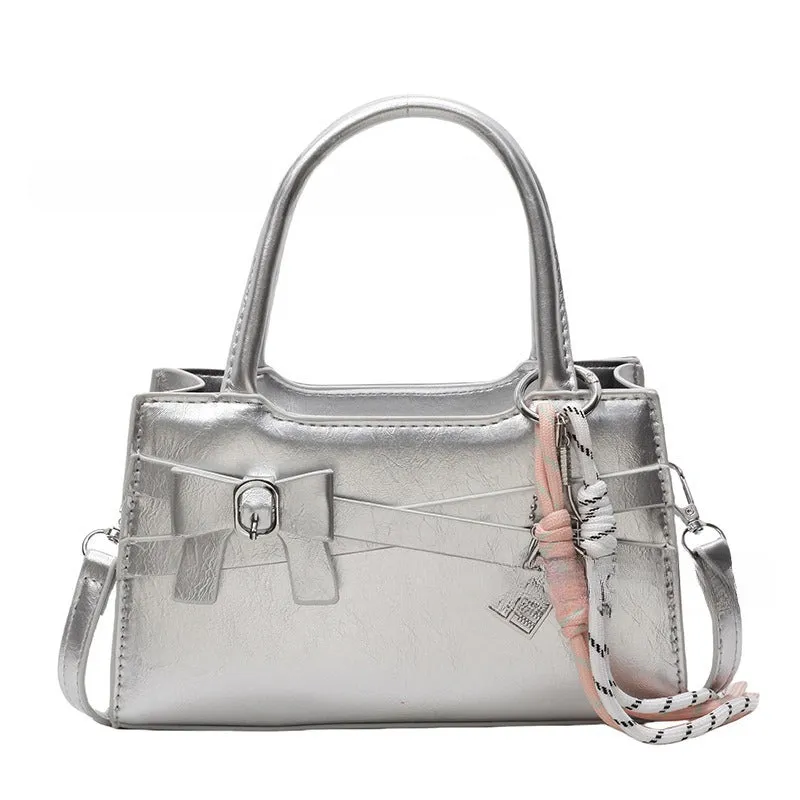 Soft nylon crossbody bag in urban simplicity, horizontal square shape, beige colour with flap pocket and stitching details.