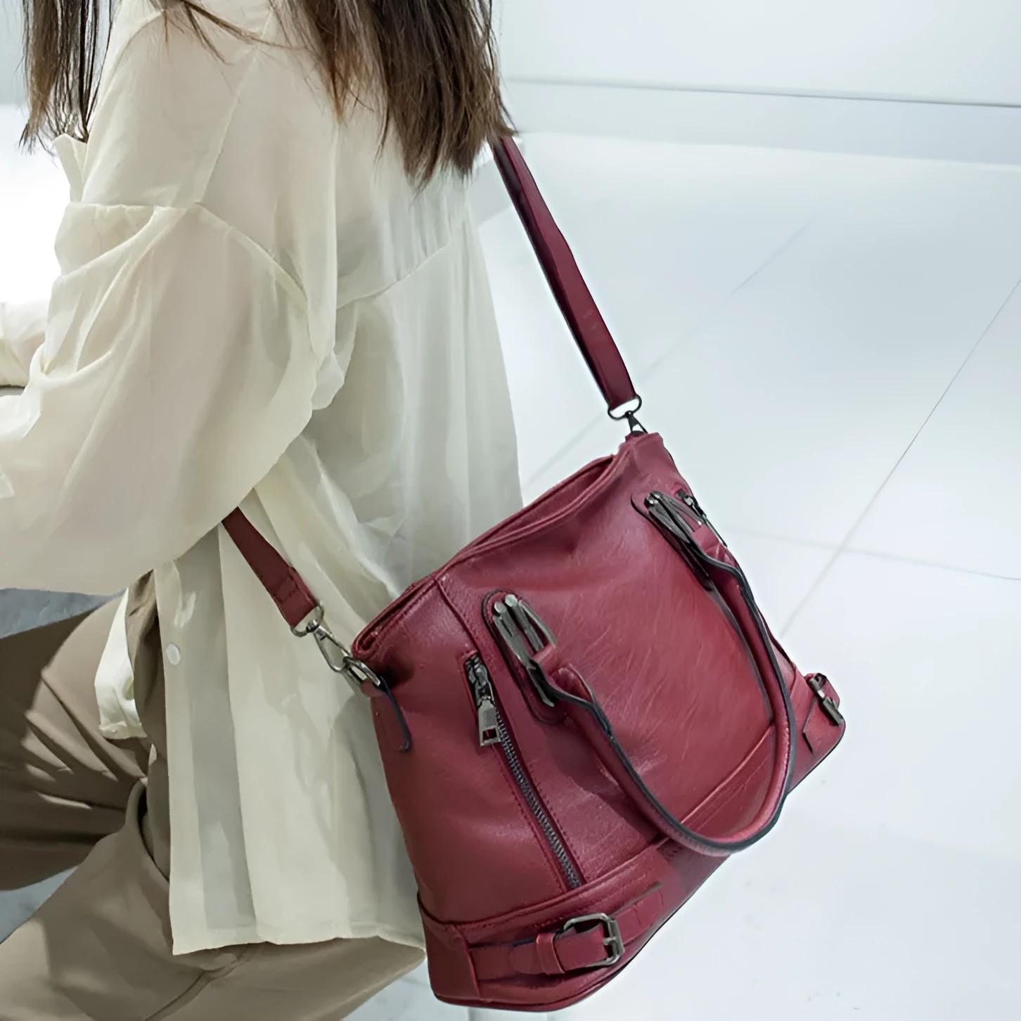 Women's PU leather handbag in black, horizontal square shape, with crossbody strap and sewing line detail