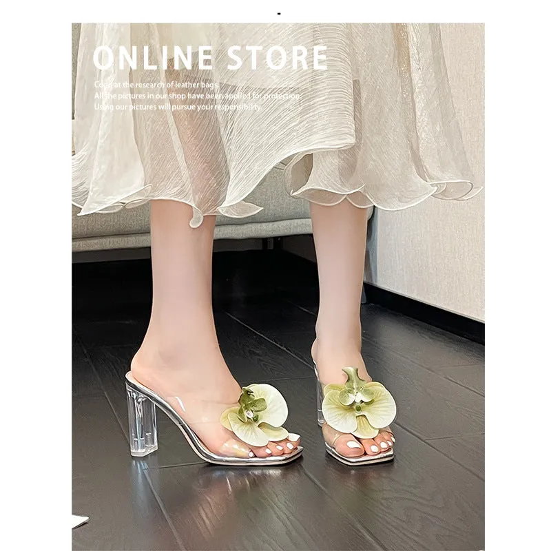 Matcha green women's high heel sandal with square toe and flower decoration on a plain background