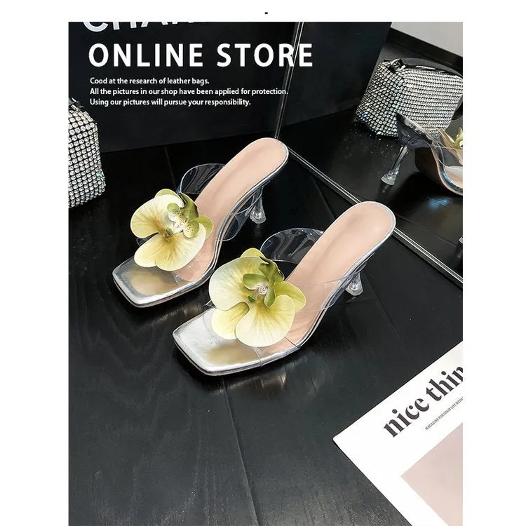 Matcha green women's high heel sandal with square toe and flower decoration on a plain background