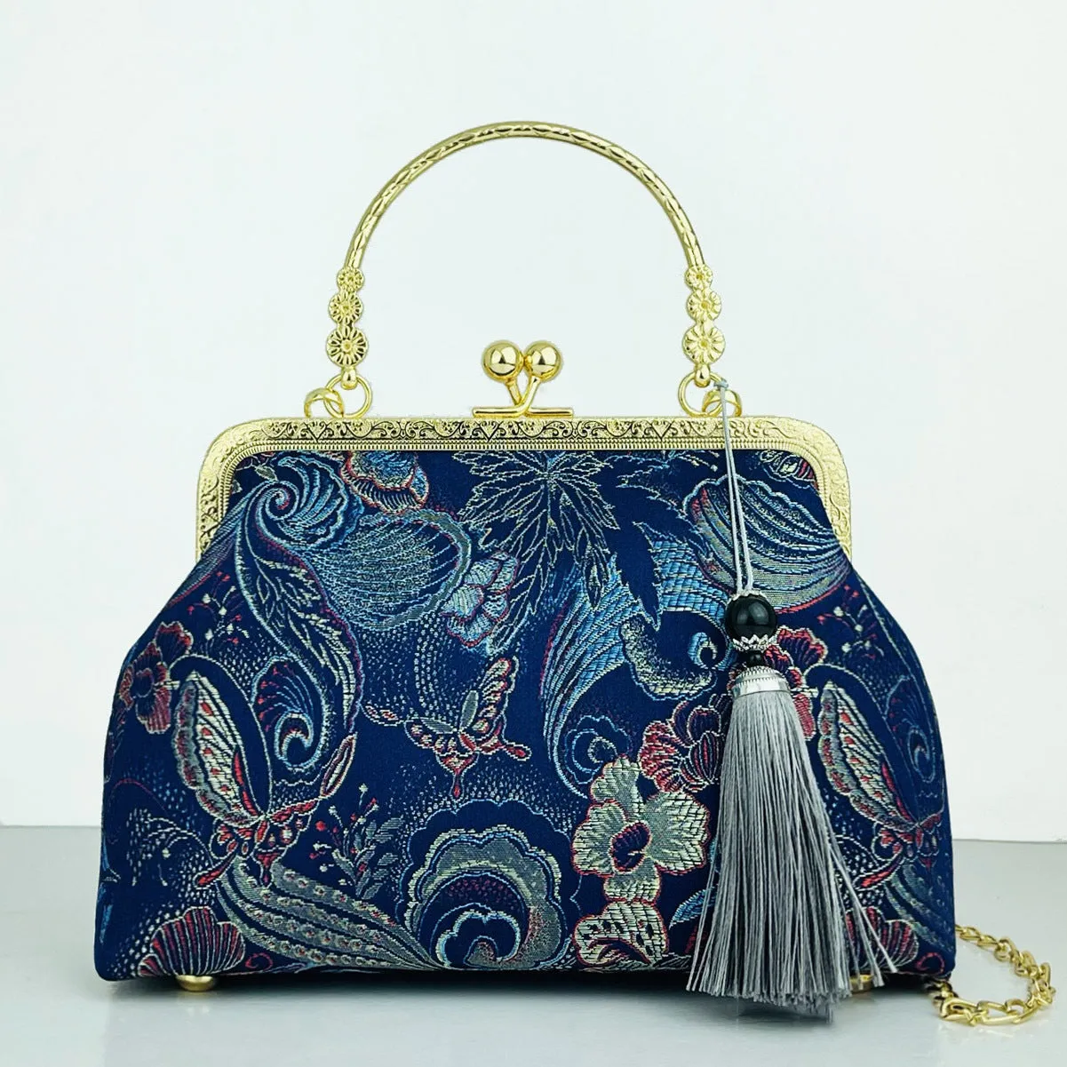 Chinese embroidery cheongsam handbag in polyester with shell shape and internal zipper compartment