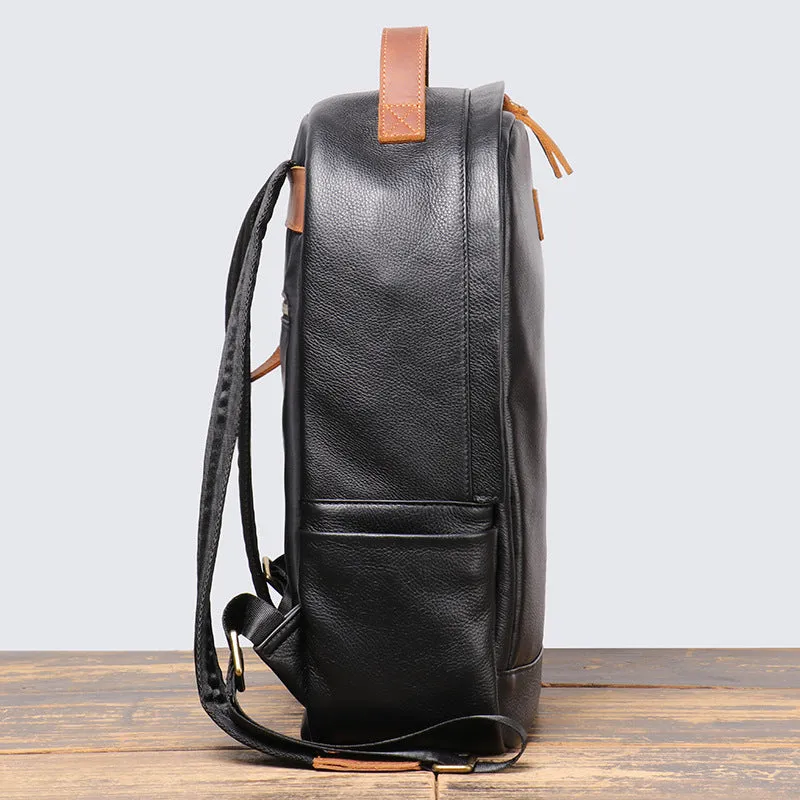 Black genuine leather expandable backpack with top grain cowhide, curved shoulder straps, and patchwork detail