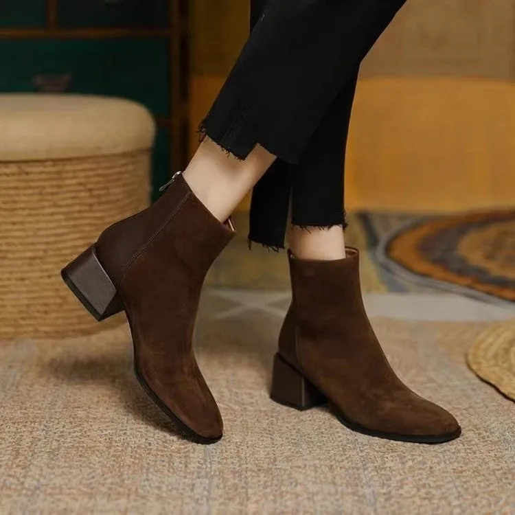 Women's suede martin boots in black with block heel and back zipper on a white background