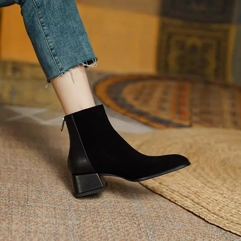 Women's suede martin boots in black with block heel and back zipper on a white background