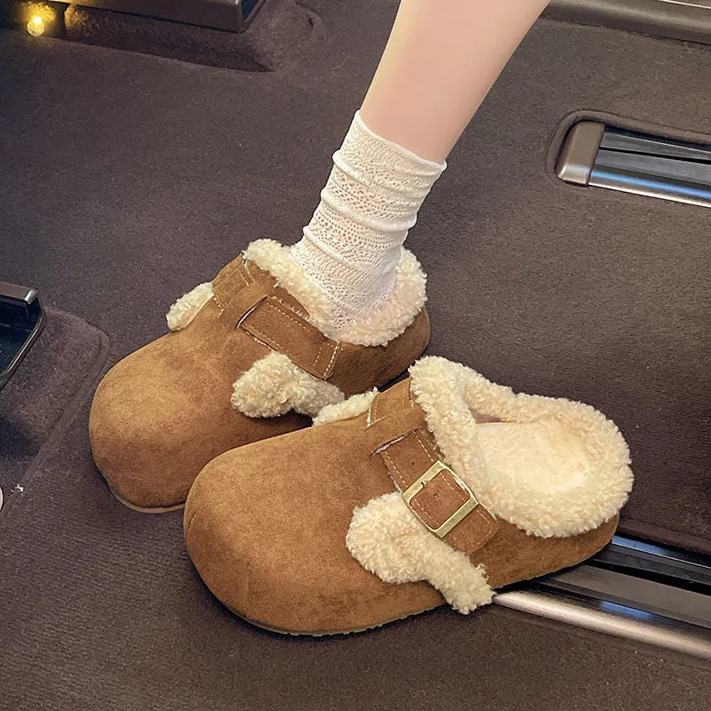 Baotou semi-drag fleece slippers in brown and camel with faux fur lining, closed toe, and rubber sole on a wooden floor