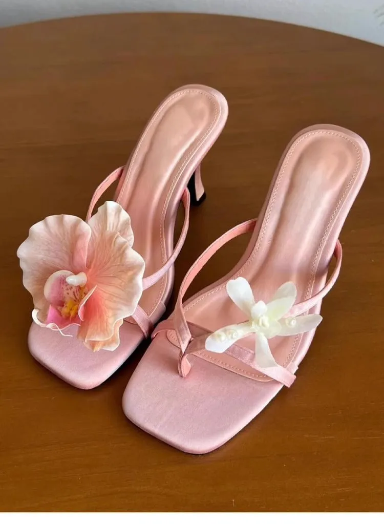 Women's handmade asymmetric flower sandals in calf leather with a square toe and high heel.
