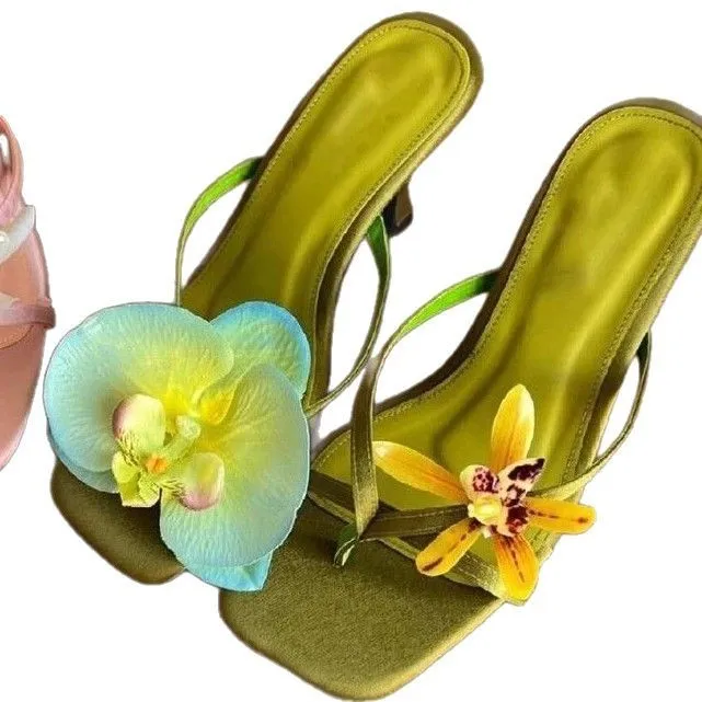Women's handmade asymmetric flower sandals in calf leather with a square toe and high heel.