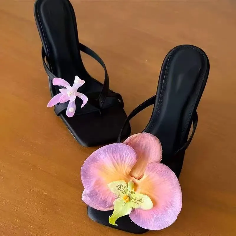 Women's handmade asymmetric flower sandals in calf leather with a square toe and high heel.