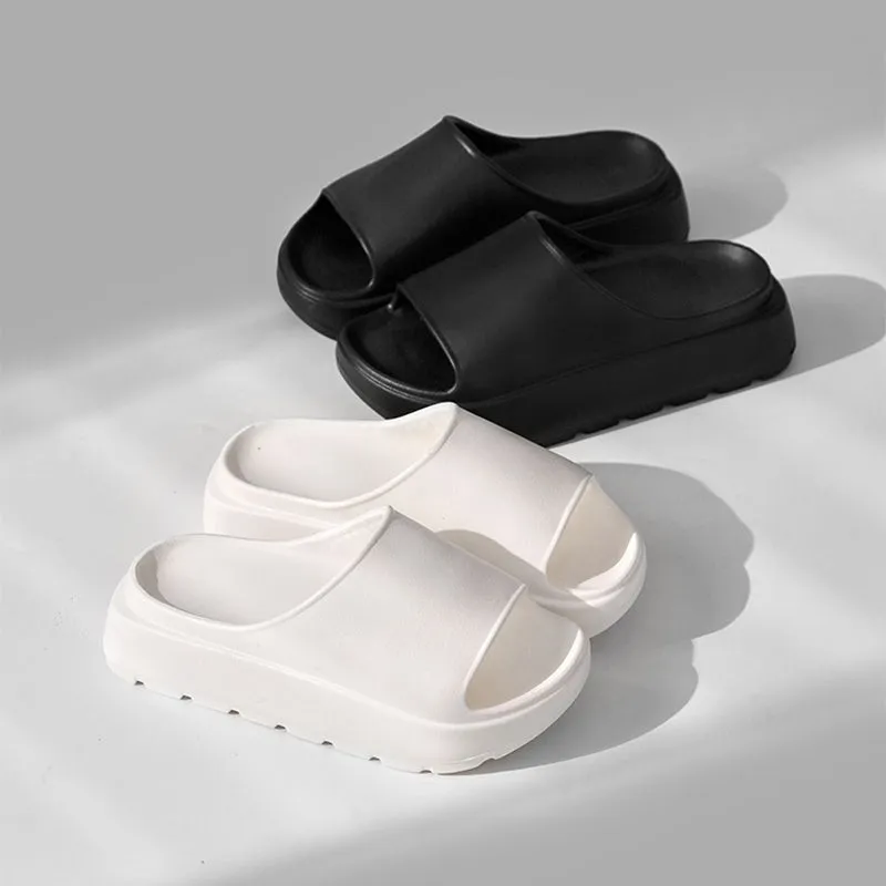 Women's beige fish mouth style EVA slippers with a thick sole, shown on a sandy beach background.