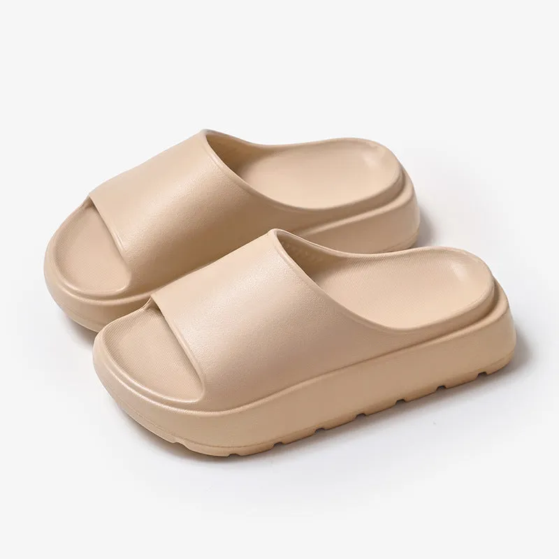 Women's beige fish mouth style EVA slippers with a thick sole, shown on a sandy beach background.