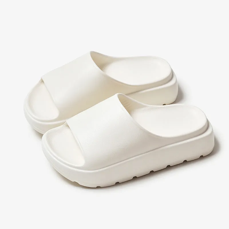 Women's beige fish mouth style EVA slippers with a thick sole, shown on a sandy beach background.