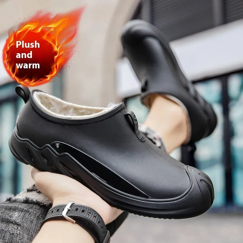 Men's black plastic rain boots showing short ankle height and solid colour design