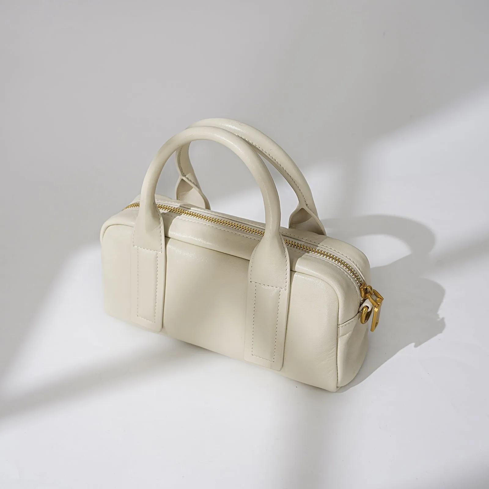 Genuine first layer cowhide crossbody bag in horizontal square shape with external sandwich pocket, available in black, brown, or milkshake white
