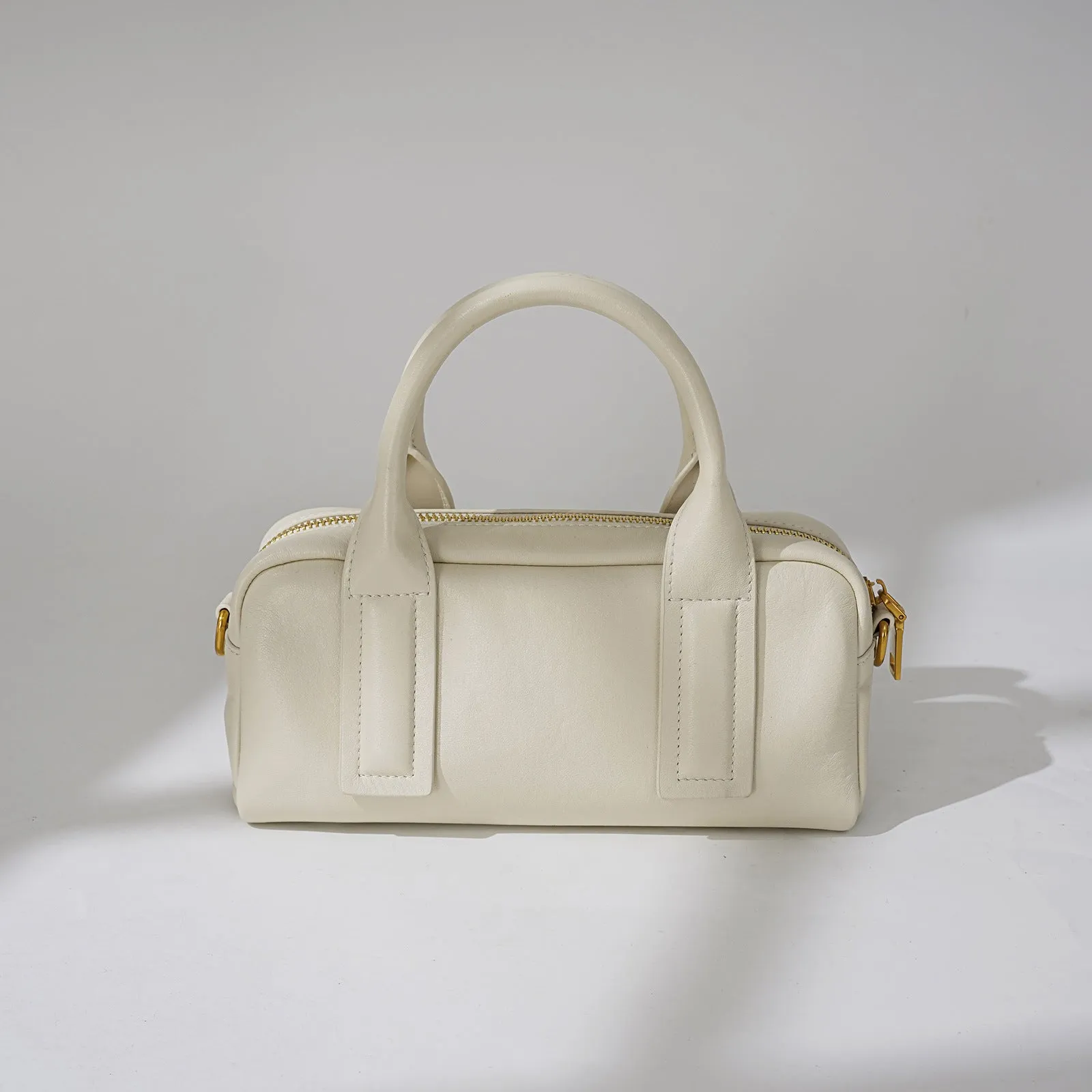 Genuine first layer cowhide crossbody bag in horizontal square shape with external sandwich pocket, available in black, brown, or milkshake white