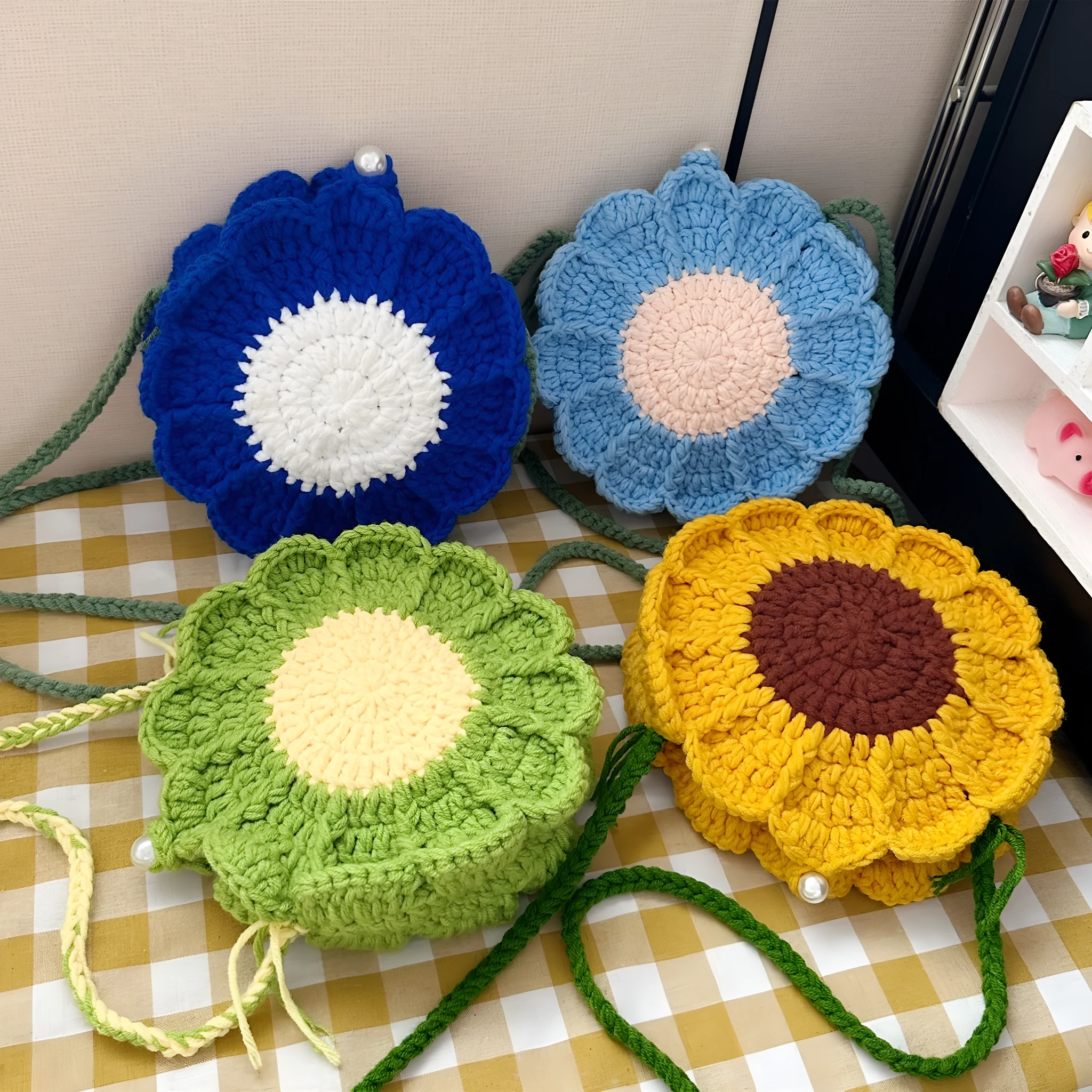 Hand-woven round bag with crocheted flowers showing cotton lining and mobile phone pouch
