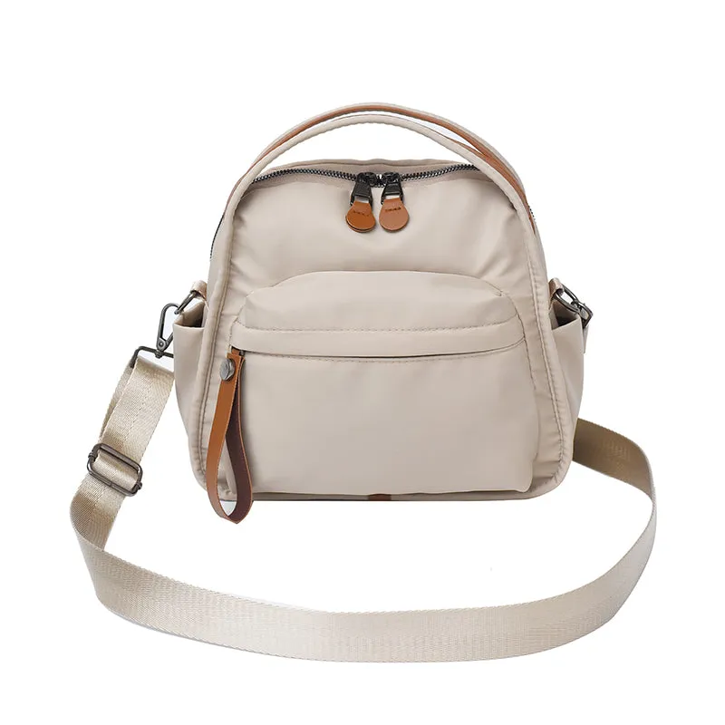 Vegan leather crossbody bag in black with double-stitched contrast thread, YKK zippers, and reinforced base