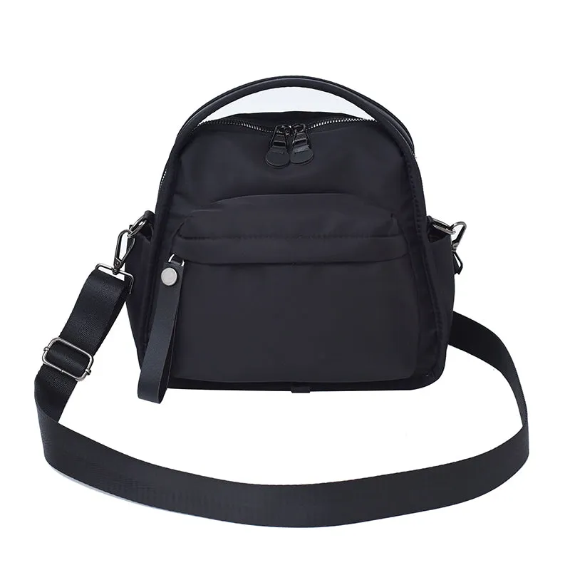 Vegan leather crossbody bag in black with double-stitched contrast thread, YKK zippers, and reinforced base