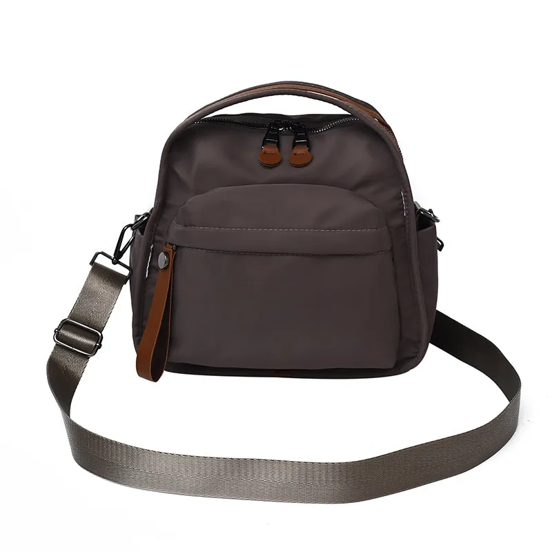 Vegan leather crossbody bag in black with double-stitched contrast thread, YKK zippers, and reinforced base