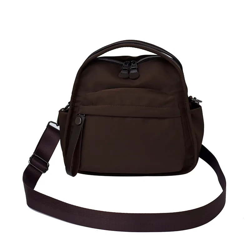 Vegan leather crossbody bag in black with double-stitched contrast thread, YKK zippers, and reinforced base