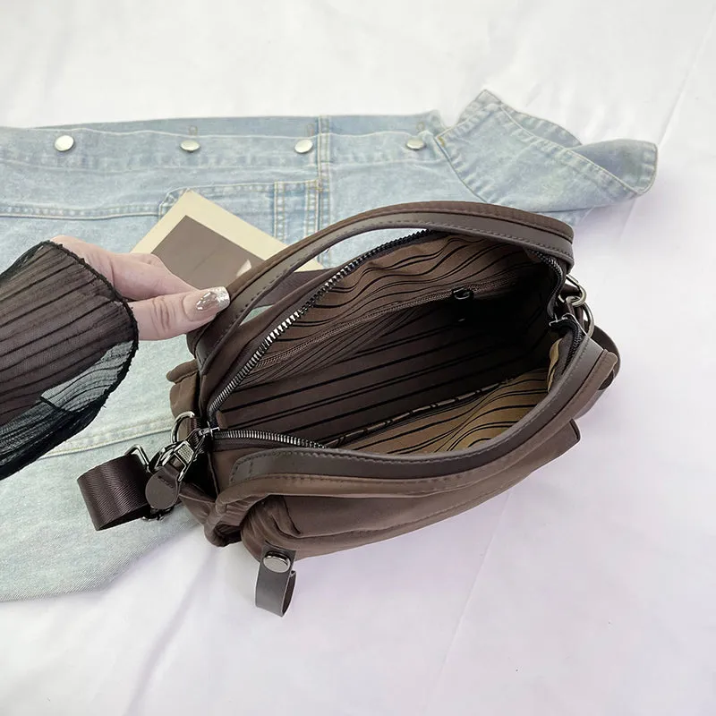 Vegan leather crossbody bag in black with double-stitched contrast thread, YKK zippers, and reinforced base