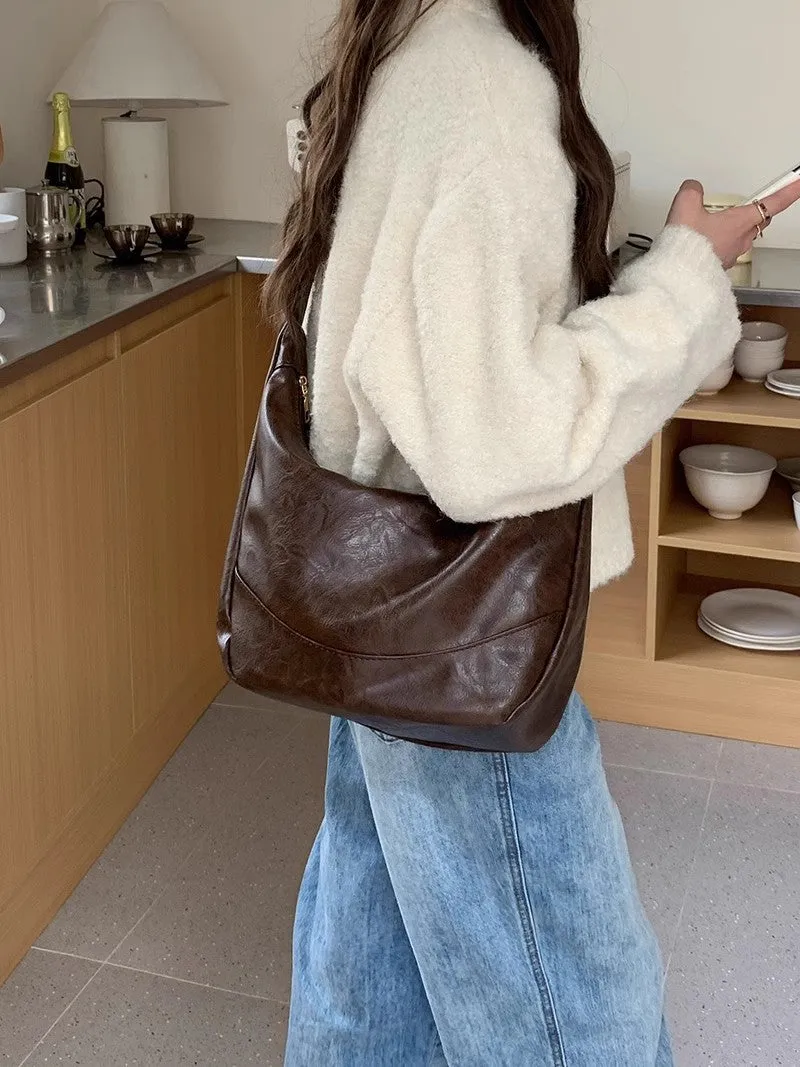 Female retro casual large capacity single shoulder crossbody bag in PU leather, brown, with sewing line detail and dumpling shape
