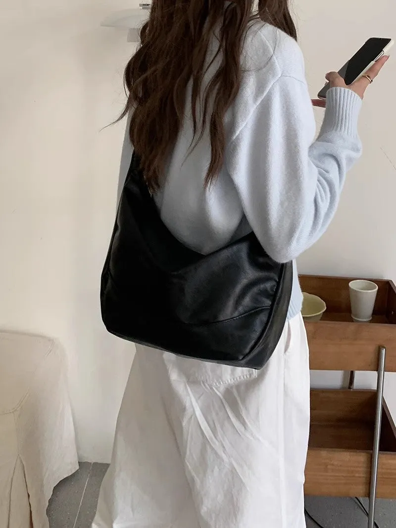 Female retro casual large capacity single shoulder crossbody bag in PU leather, brown, with sewing line detail and dumpling shape