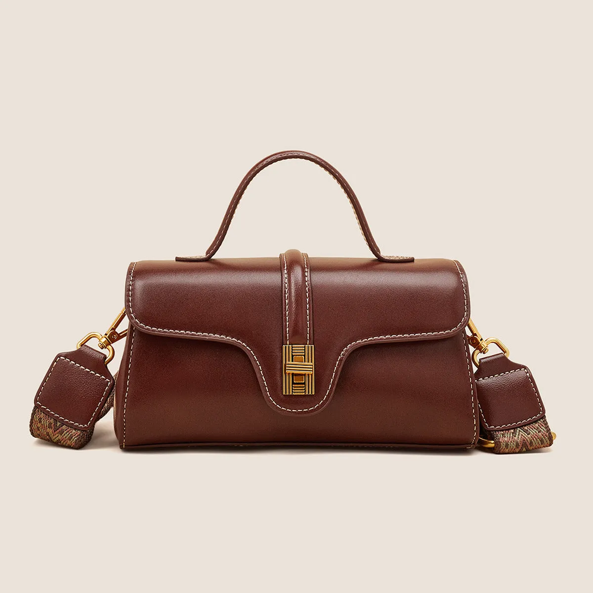 Cambridge-style leather messenger bag in clamshell design with lock detail and internal compartments