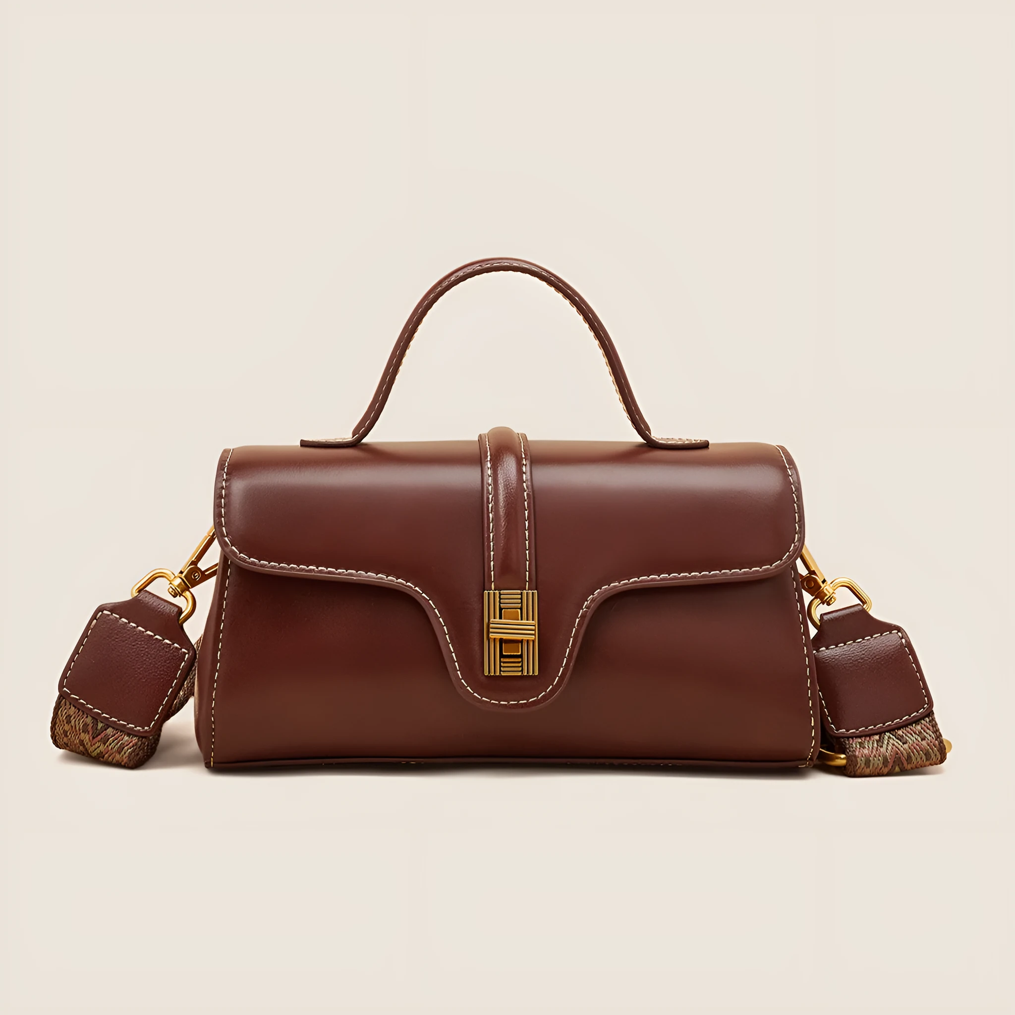 Cambridge-style leather messenger bag in clamshell design with lock detail and internal compartments