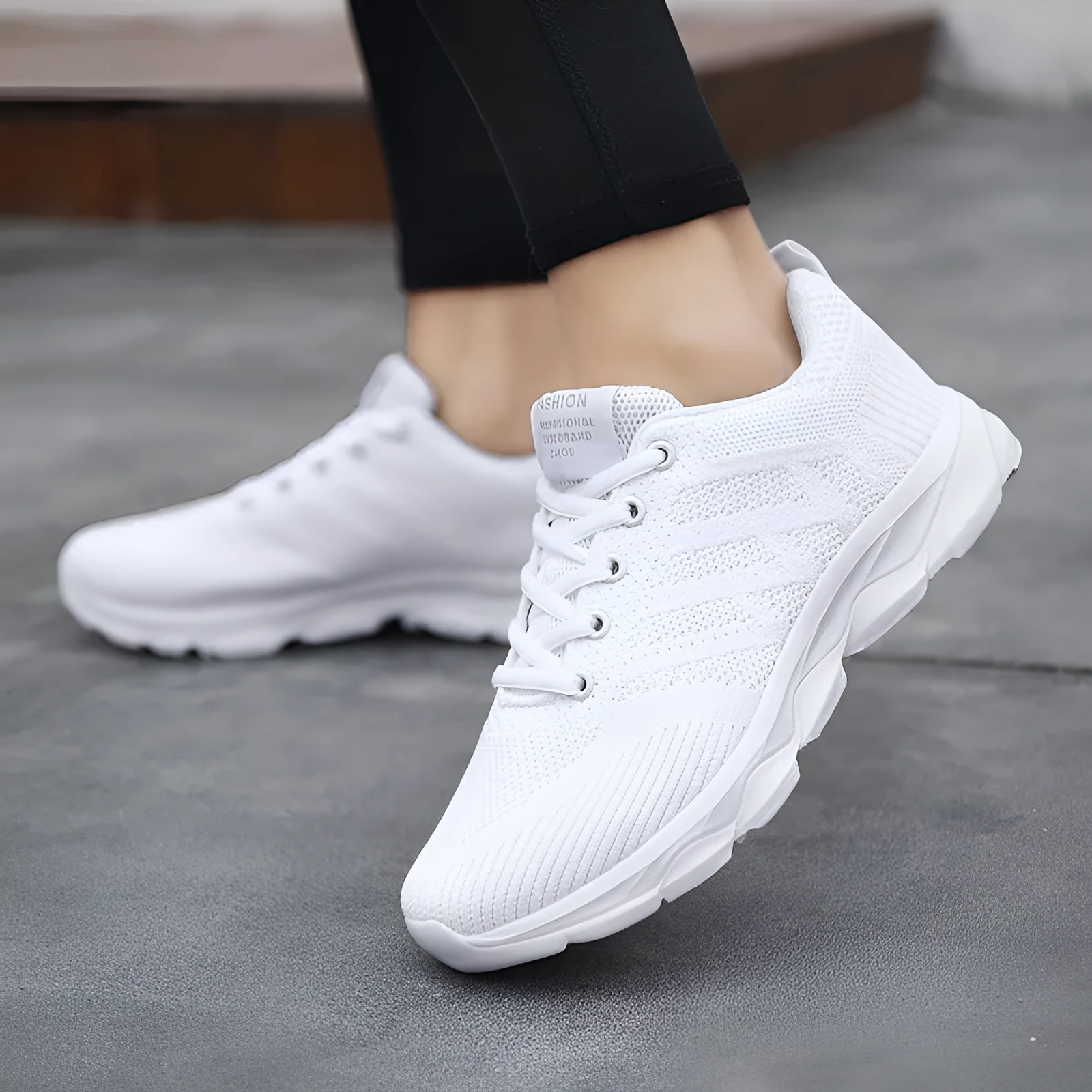Women's sports running shoes in white with mesh and Flyknit upper, flat heel, and lace-up front