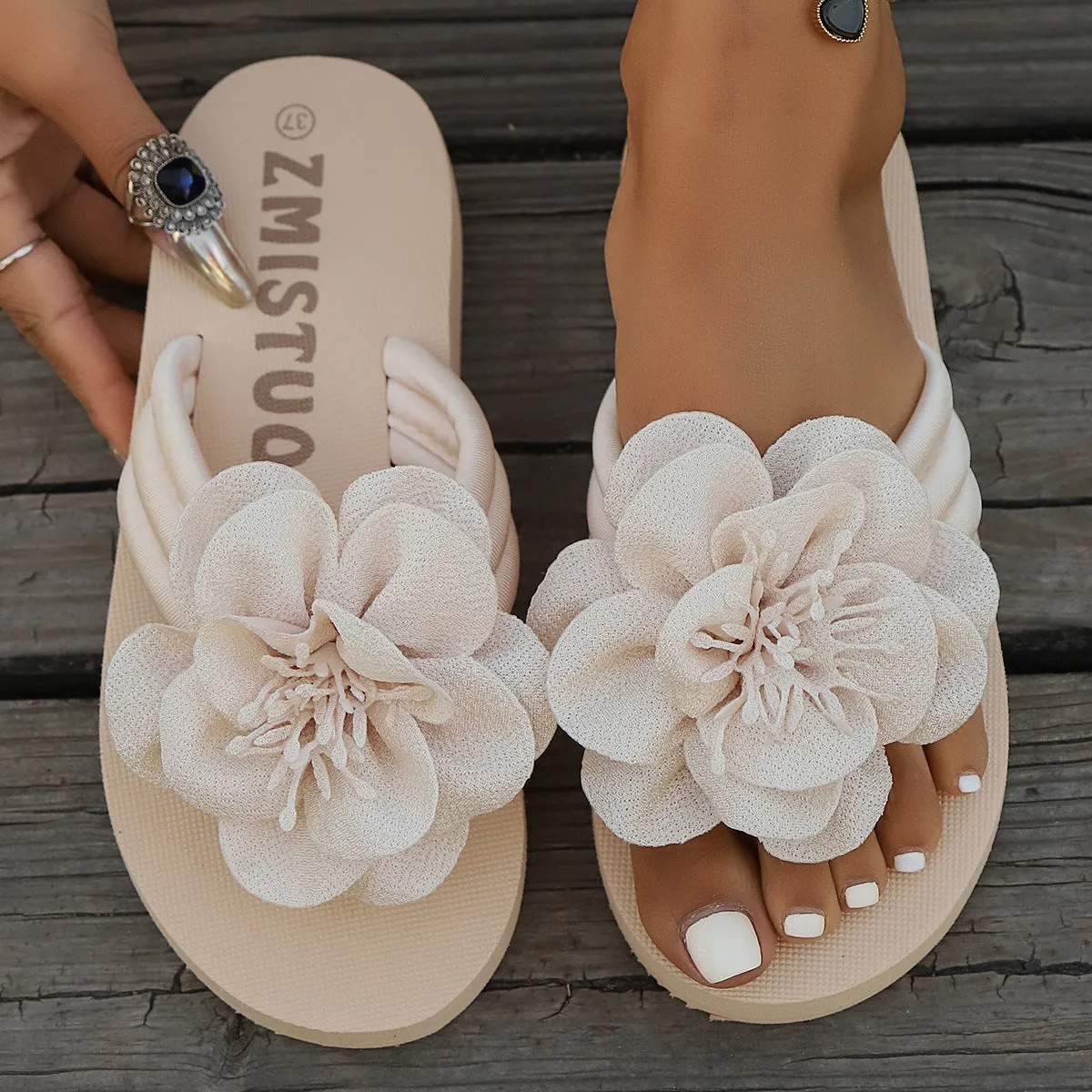 Women's solid colour PU upper flower flat toe flip-flop sandal in beige white, side view