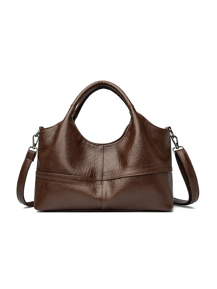 Soft leather crossbody handbag in black, bucket shape with single shoulder strap, lightweight design for women