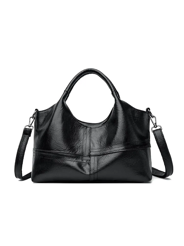 Soft leather crossbody handbag in black, bucket shape with single shoulder strap, lightweight design for women