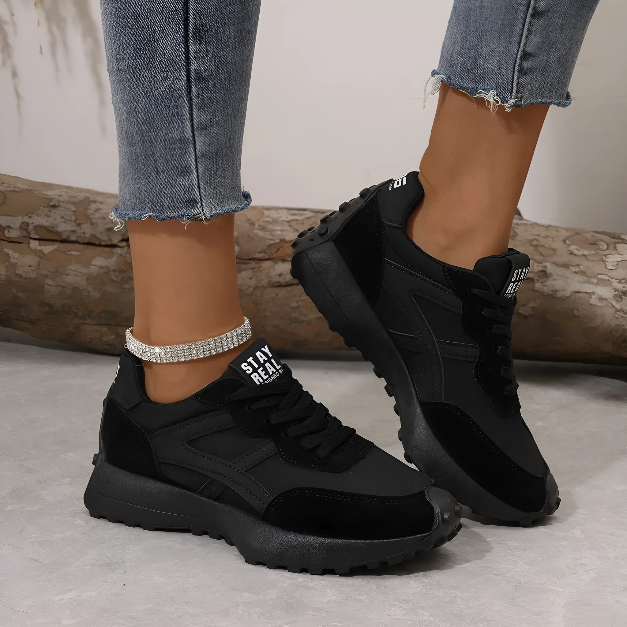 Black mesh sports flat shoes for women with synthetic leather upper and rubber sole, side view