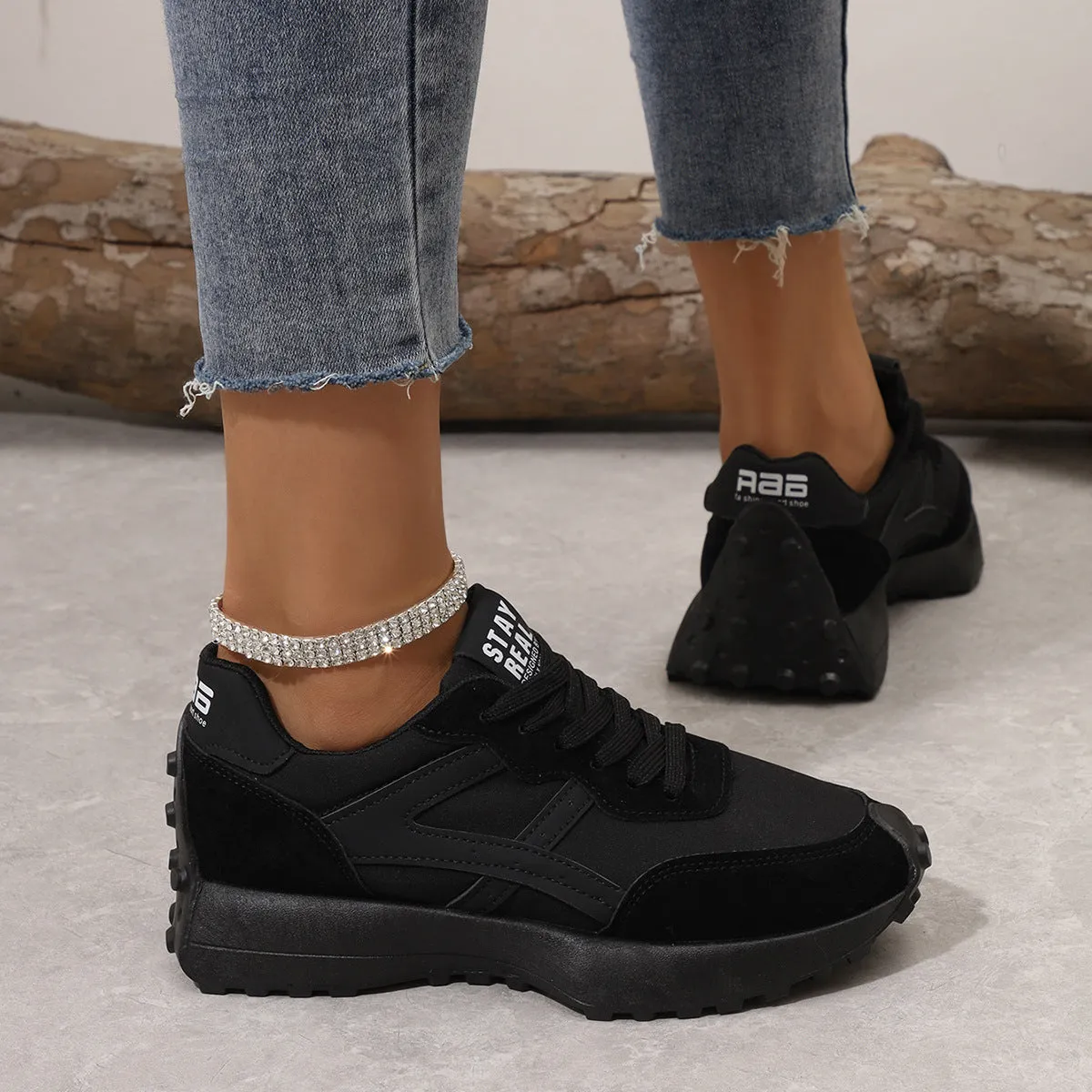 Black mesh sports flat shoes for women with synthetic leather upper and rubber sole, side view