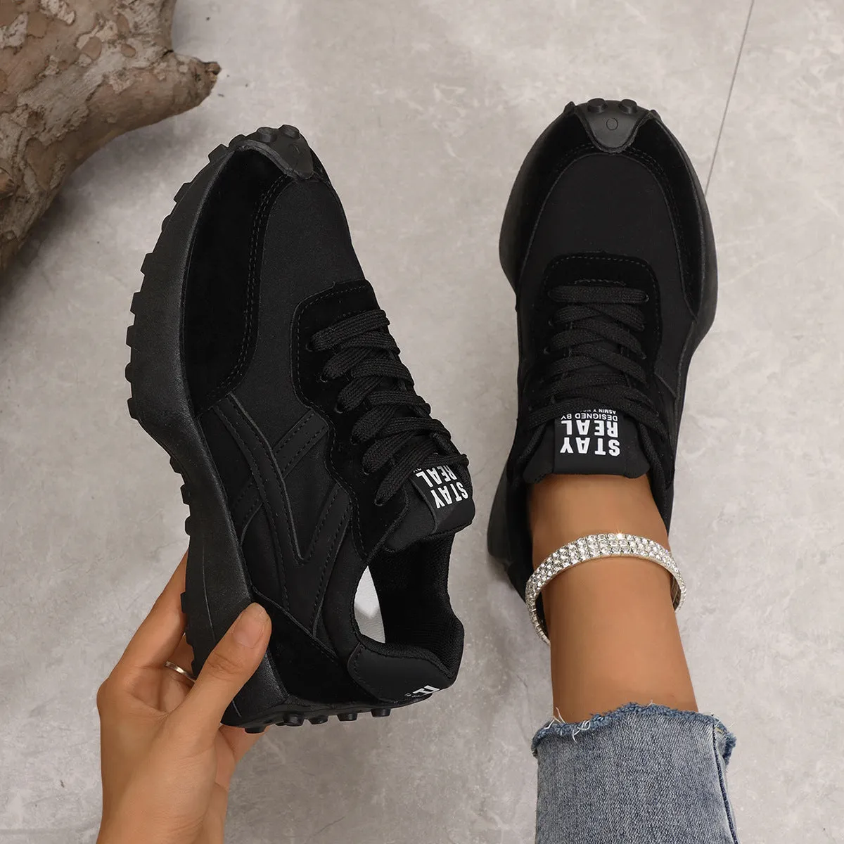 Black mesh sports flat shoes for women with synthetic leather upper and rubber sole, side view