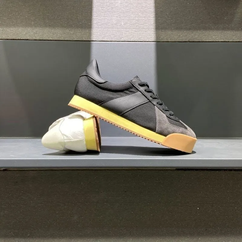 Men's grey suede and mesh sports shoe with a raised heel and herringbone pattern on the toe.