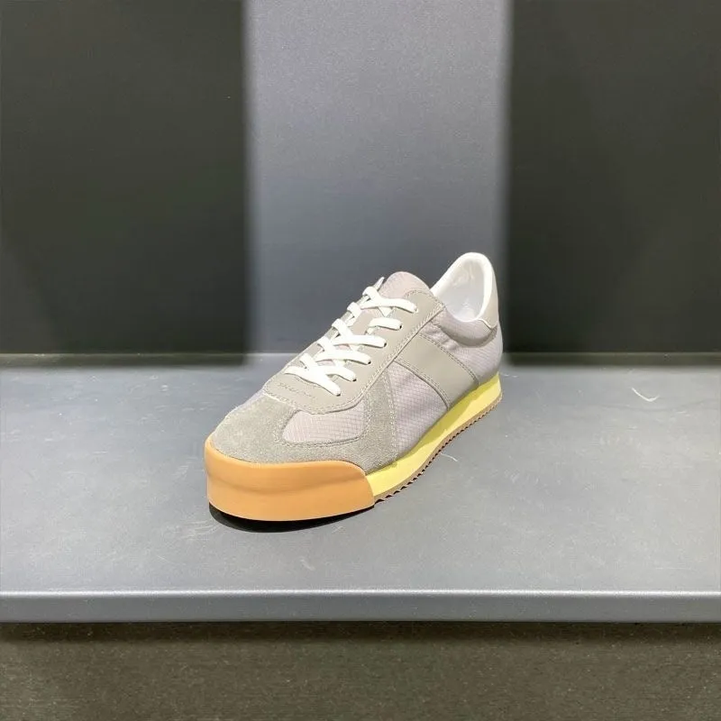 Men's grey suede and mesh sports shoe with a raised heel and herringbone pattern on the toe.