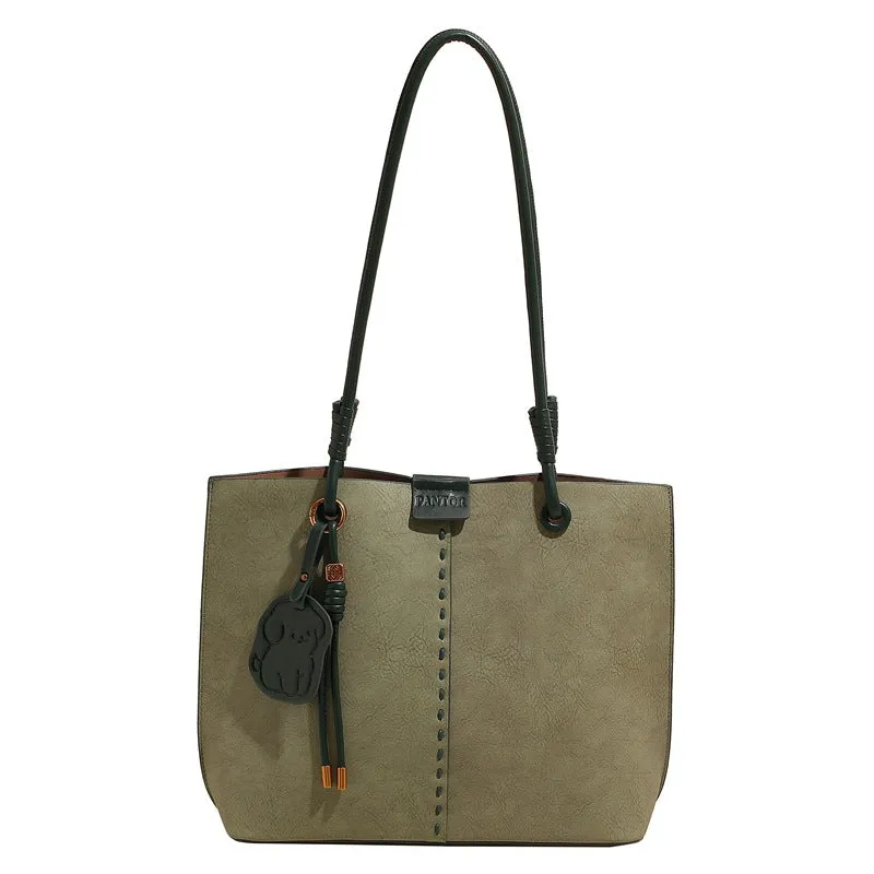 Green urban minimalist PU shoulder bag with stitching detail and double straps on a white background.