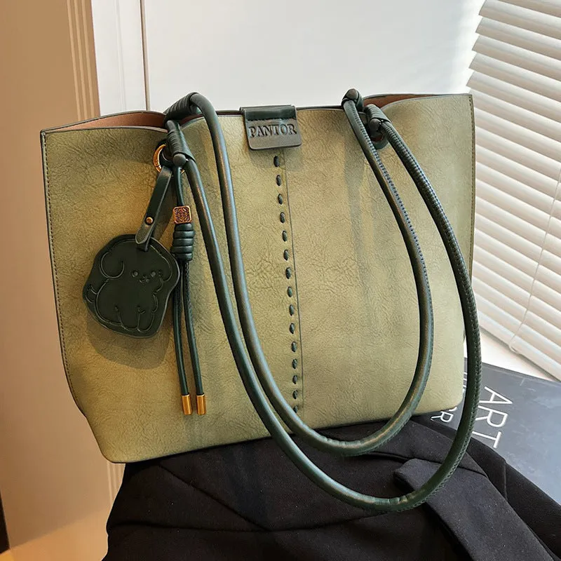 Green urban minimalist PU shoulder bag with stitching detail and double straps on a white background.